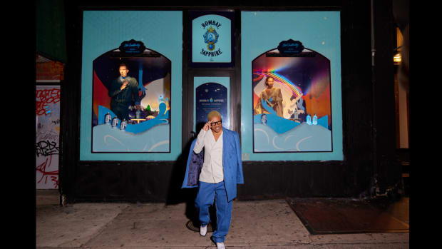 Romeo Hunte stands in front of his Bombay Sapphire  Holiday Storefront Series window.