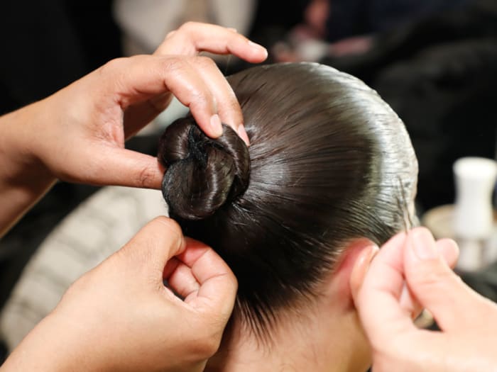 A model prepares backstage for TRESemme x LaQuan Smith at 60 Pine Street on February 14, 2022 in New York City.