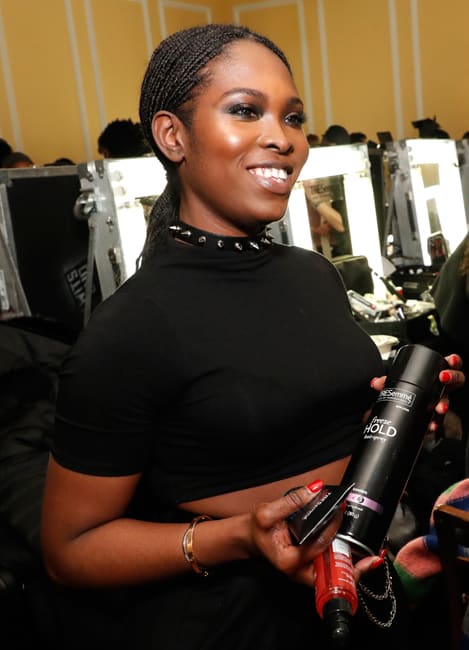 TRESemmé lead hairstylist Lacy Redway uses TRESemme Freeze Hold Hair Spray backstage for TRESemme x LaQuan Smith at 60 Pine Street on February 14, 2022 in New York City.