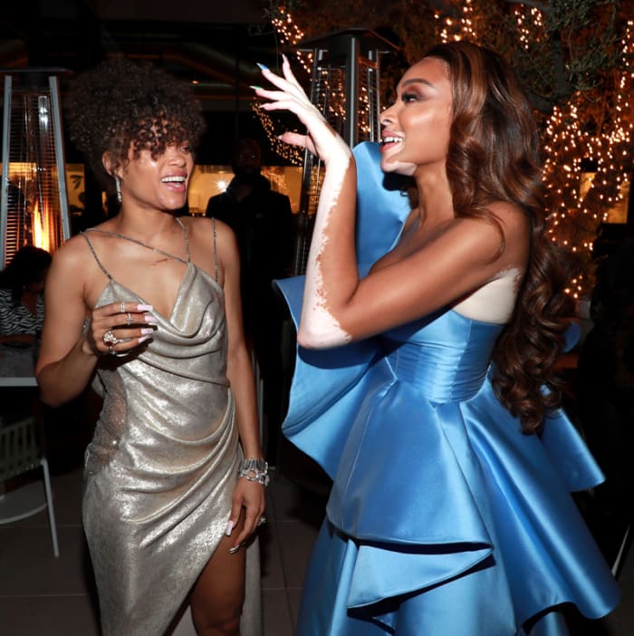 Andra Day and friend Winnie Harlow share a moment at an Oscars party thrown in Day's honor.
