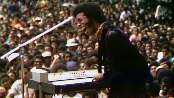 Sly and the Family Stone entertain thousands of people during the Harlem Cultural Festival.