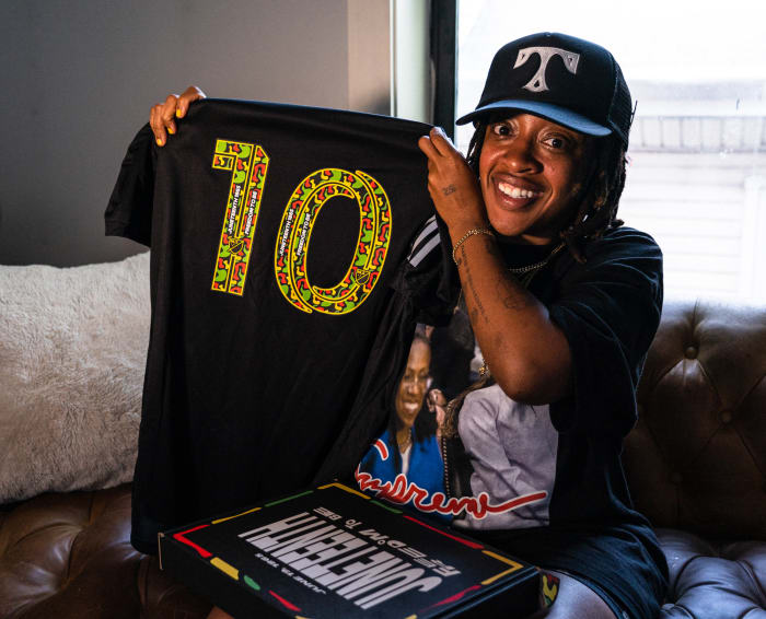 Judah Middleton holds one of jerseys she designed for MLS and Black Players for Change's Juneteenth commemoration.
