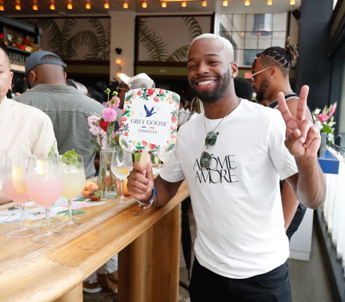 A guest helps Grey Goose Essences celebrate "The Main Character, a Tribute to Black Excellence."