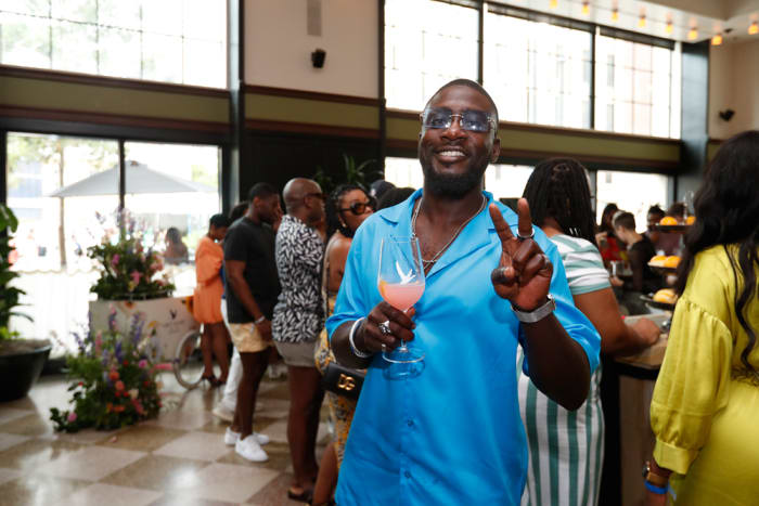 A guest helps Grey Goose Essences celebrate "The Main Character, a Tribute to Black Excellence."