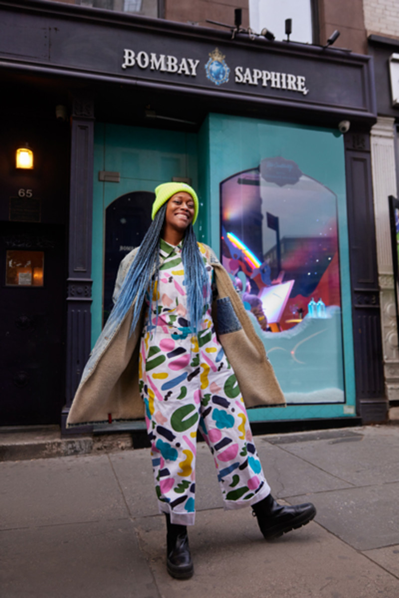 Visual artist Shavanté Royster strikes a pose in front of her Bombay Sapphire Holiday Storefront Series dedicated window at 65 Spring Street.