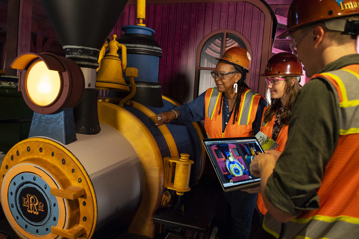 Walt Disney Imagineering executive producer Charita Carter and the Imagineering team putting the final touches on Mickey & Minnie’s Runaway Railway.