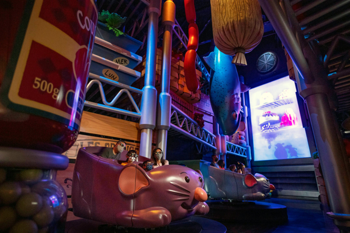 A family takes a ride through Remy's Ratatouille Adventure at Disney's EPCOT.